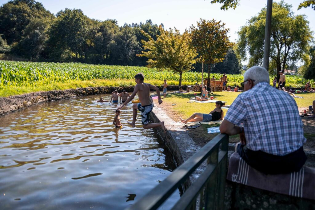 pessoas a tomar banho na praia fluvial de Arnoso